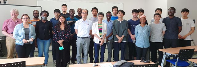 Group photo of lecturers and students in a classroom
